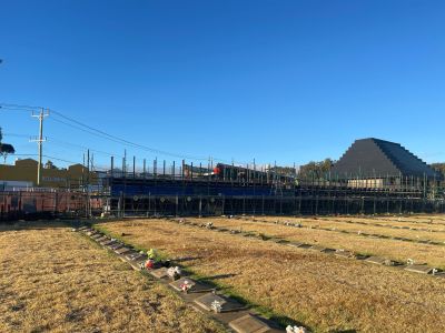 View of a lawn cemetery with construction in the background