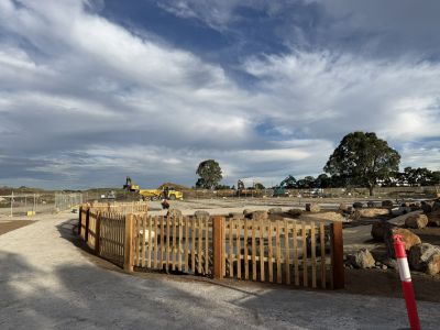 A new wooden fence surrounding a recently developed burial area at a cemetery. 